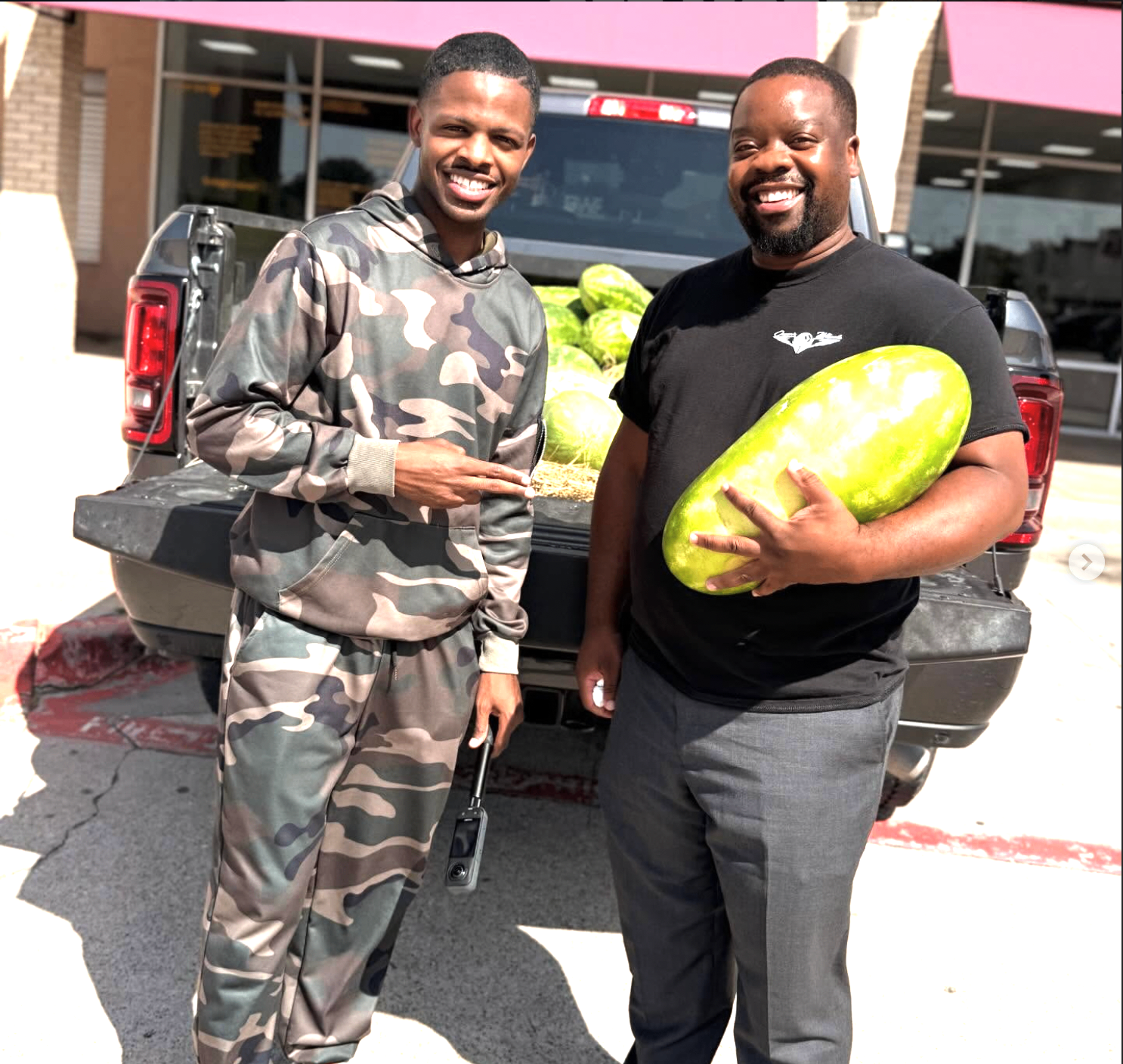 Two Straight D.R.O.P. supporters with a truck bed full of watermelon