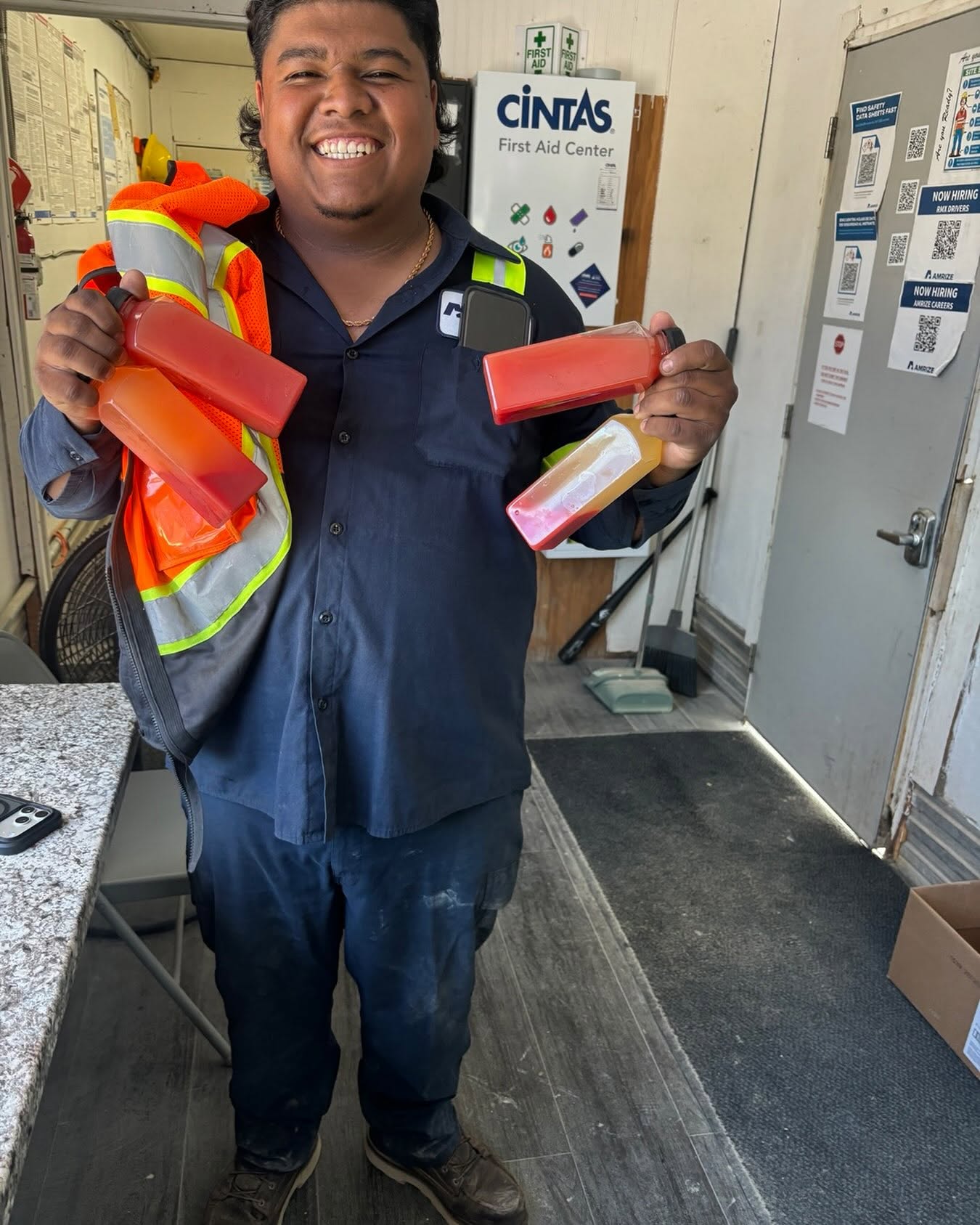 Customer holding four bottles of fresh watermelon juice